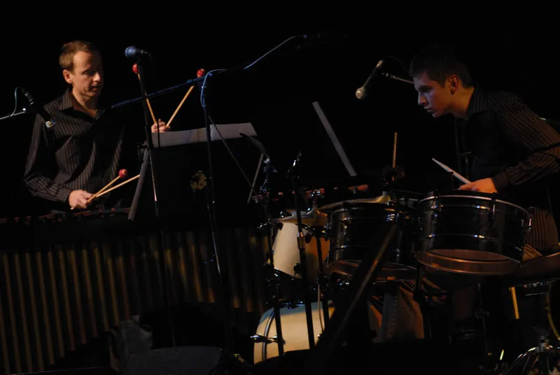 The duo performing live on a dark stage